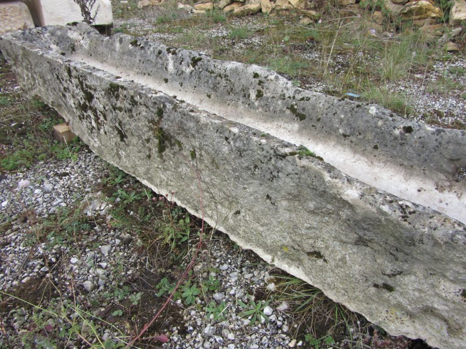 long and narrow very old French sandstone trough